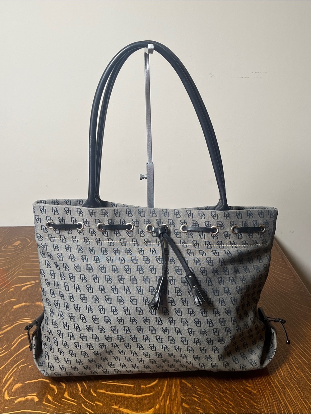 Dooney & Bourke Vintage Gray Canvas Monogram Tote with Black Trim and Tassel.